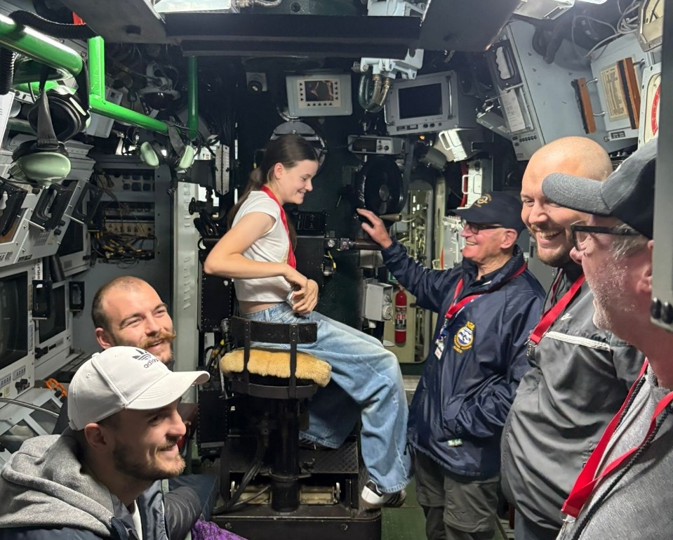 Visitors touring submarine controls